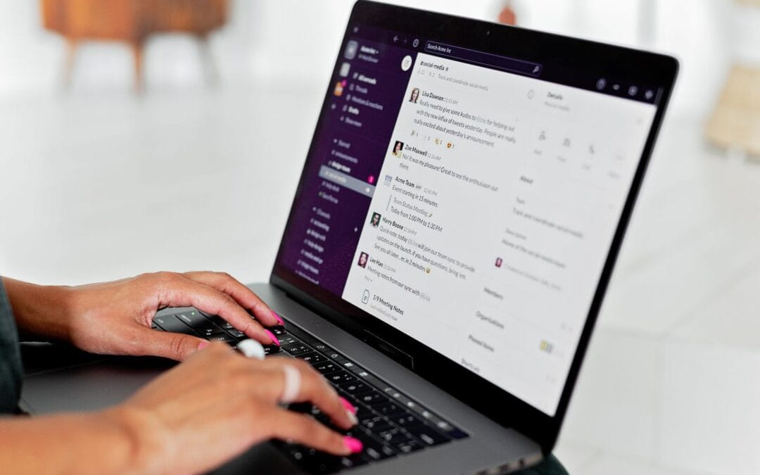 Person typing a question into an AI chat app on a laptop, asking for a local business recommendation